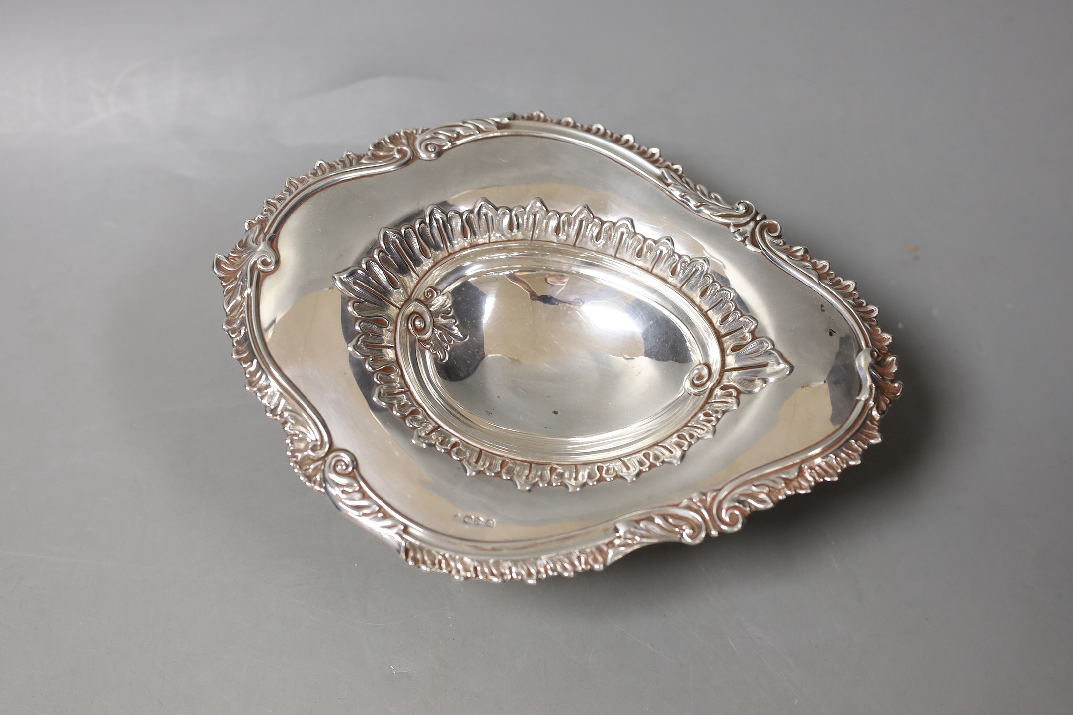 A late Victorian silver oval pedestal dish, James Deakin & Sons, Chester, 1894, 22cm and a similar repousse silver bonbon dish, 6.5oz.